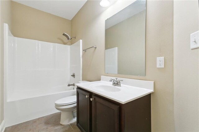 full bathroom with tile patterned flooring, toilet, vanity, and shower / tub combination