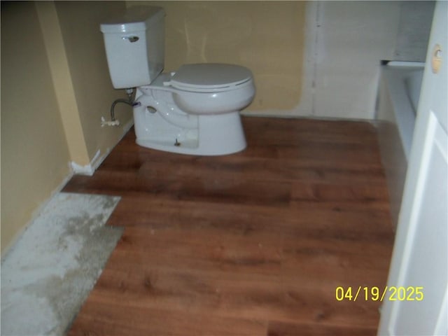 bathroom with wood finished floors and toilet