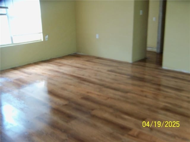 unfurnished room with wood finished floors