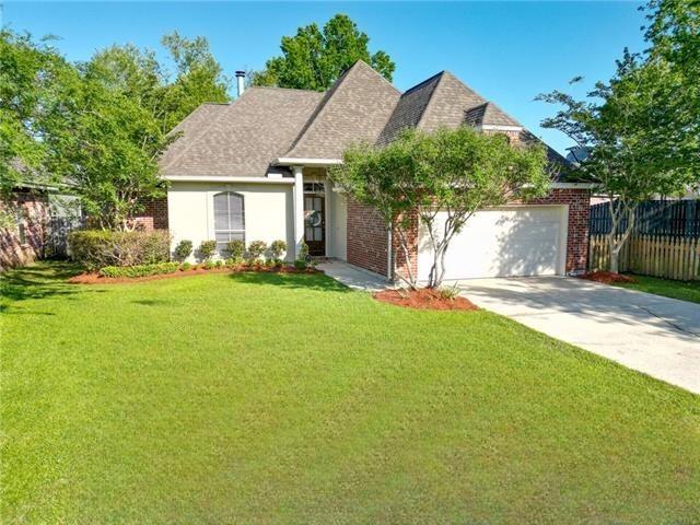 2436 Cours Carson St, Mandeville, LA 70448 - traditional-style house with a garage, driveway, and brick siding