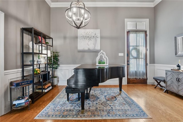 2436 Cours Carson St, Mandeville, LA 70448 - living area with a chandelier, crown molding, wood finished floors, and a wainscoted wall