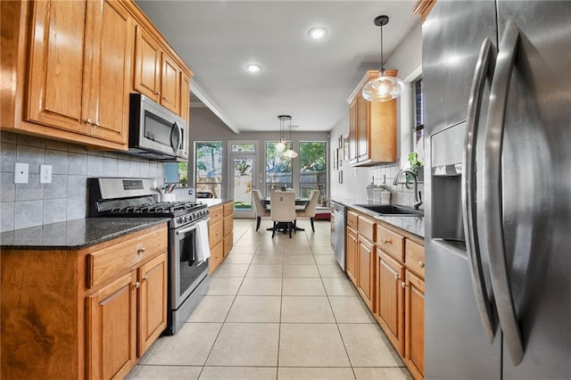 2436 Cours Carson St, Mandeville, LA 70448 - kitchen with appliances with stainless steel finishes, a sink, light tile patterned floors, decorative backsplash, and recessed lighting