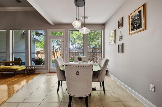 2436 Cours Carson St, Mandeville, LA 70448 - dining area featuring baseboards, light tile patterned floors, and ornamental molding