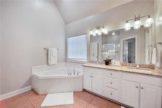 2436 Cours Carson St, Mandeville, LA 70448 - full bathroom featuring vaulted ceiling, tile patterned floors, a shower stall, double vanity, and a garden tub