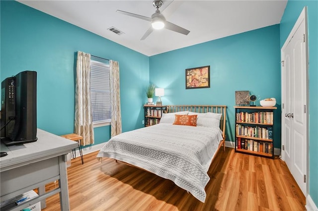 2436 Cours Carson St, Mandeville, LA 70448 - bedroom featuring wood finished floors, baseboards, and a ceiling fan