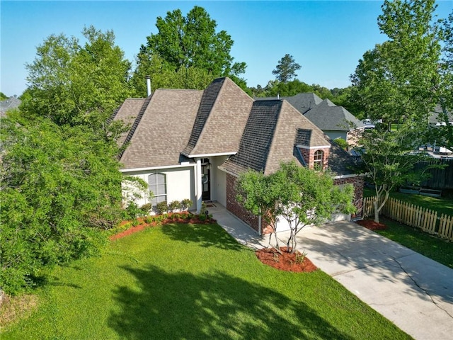 2436 Cours Carson St, Mandeville, LA 70448 - view of front facade with a shingled roof, driveway, a garage, and stucco siding