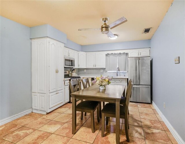 1208 Maine Ave, Kenner, LA 70062 - dining space with a ceiling fan, baseboards, and light tile patterned floors