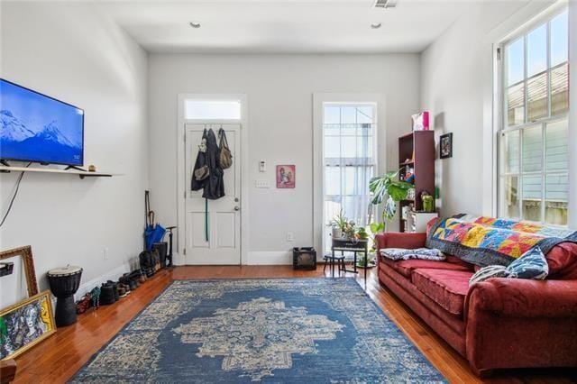 264545 Saint Ann St, New Orleans, LA 70119 - living room featuring plenty of natural light, baseboards, and wood finished floors