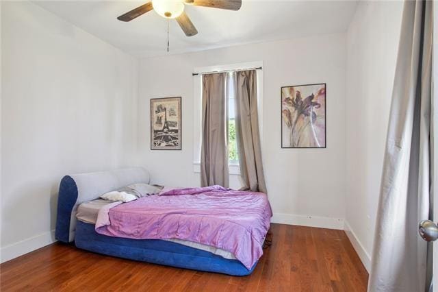 264545 Saint Ann St, New Orleans, LA 70119 - bedroom with wood finished floors, a ceiling fan, and baseboards