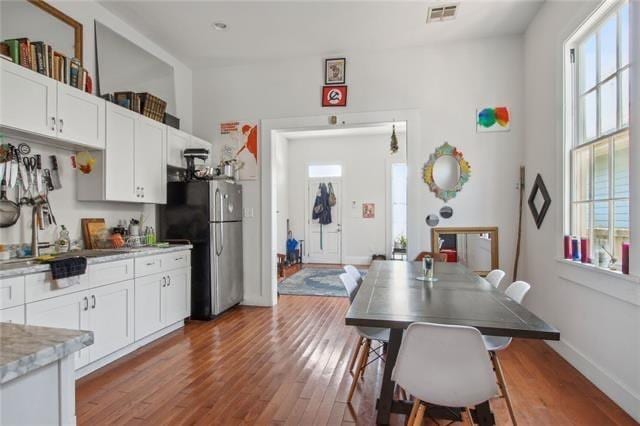 264545 Saint Ann St, New Orleans, LA 70119 - kitchen featuring wood finished floors, visible vents, and a healthy amount of sunlight