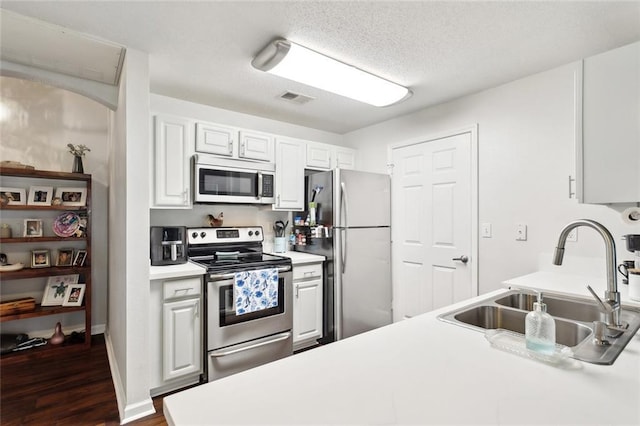 350 Emerald Forest Blvd Unit 9102, Covington, LA 70433 - kitchen with a sink, dark wood finished floors, visible vents, light countertops, and appliances with stainless steel finishes