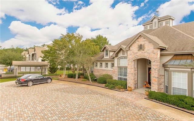 350 Emerald Forest Blvd Unit 9102, Covington, LA 70433 - view of front of house with fence and stone siding