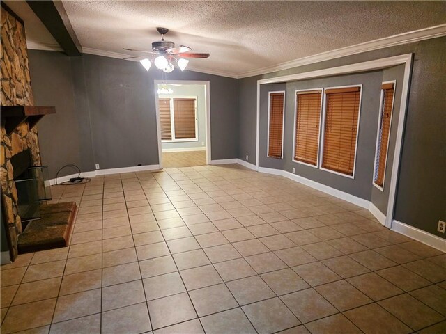 4967A Jean Lafitte Blvd, Lafitte, LA 70067 - unfurnished living room featuring crown molding, a ceiling fan, a textured ceiling, tile patterned flooring, and a fireplace
