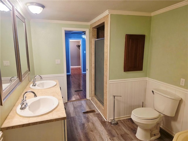 4967A Jean Lafitte Blvd, Lafitte, LA 70067 - full bathroom with wood finished floors, a shower stall, wainscoting, toilet, and crown molding