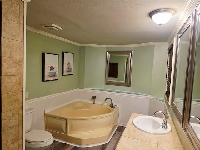 4967A Jean Lafitte Blvd, Lafitte, LA 70067 - bathroom with a textured ceiling, a wainscoted wall, toilet, a garden tub, and a sink