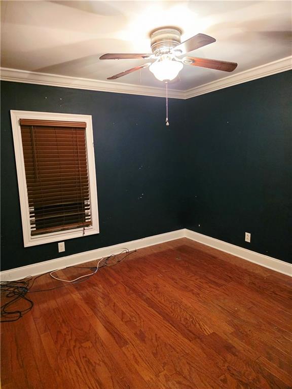 4967A Jean Lafitte Blvd, Lafitte, LA 70067 - spare room with wood finished floors, ceiling fan, baseboards, and crown molding