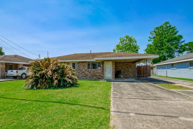 ranch-style home with a front lawn, driveway, fence, an attached carport, and brick siding