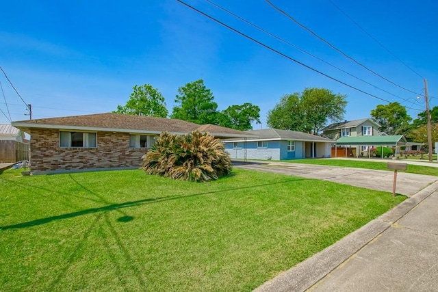 ranch-style home with brick siding, a front yard, and fence