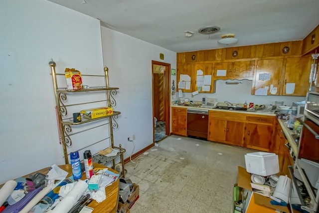 kitchen featuring light floors, light countertops, dishwashing machine, visible vents, and brown cabinetry