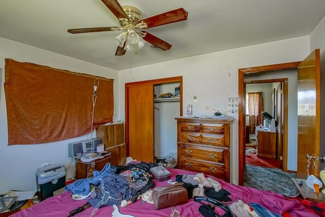 bedroom with carpet floors, a closet, and a ceiling fan