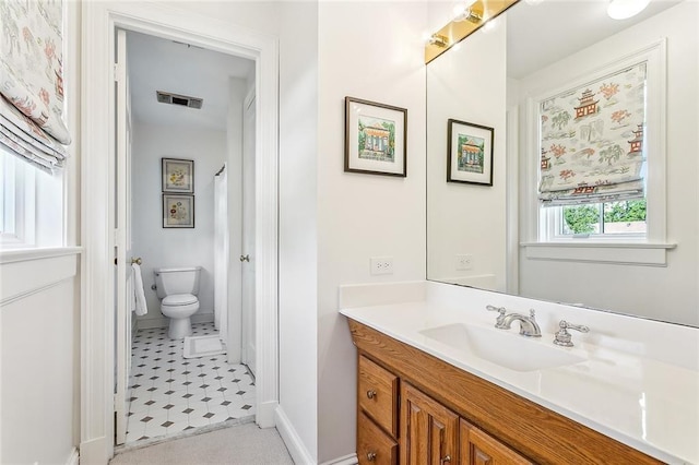 10005 Sauve Oak Ln, River Ridge, LA 70123 - bathroom featuring vanity, baseboards, toilet, tile patterned flooring, and visible vents