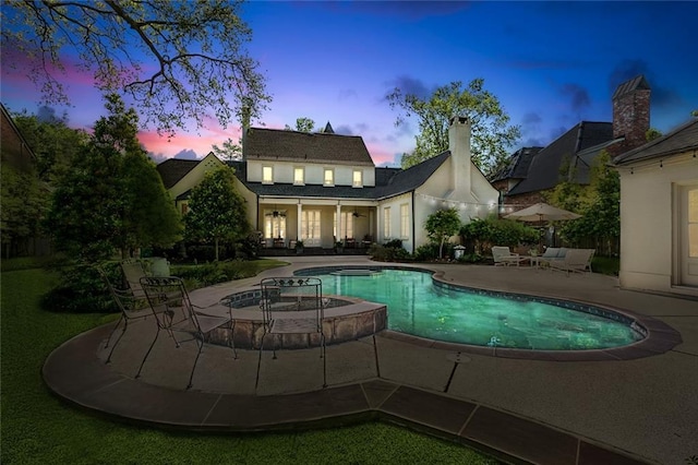 10005 Sauve Oak Ln, River Ridge, LA 70123 - back of property at dusk featuring a patio area and an outdoor pool