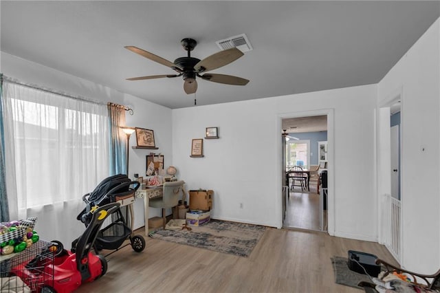 office area featuring wood finished floors, a ceiling fan, and baseboards