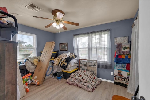 bedroom with wood finished floors and a ceiling fan