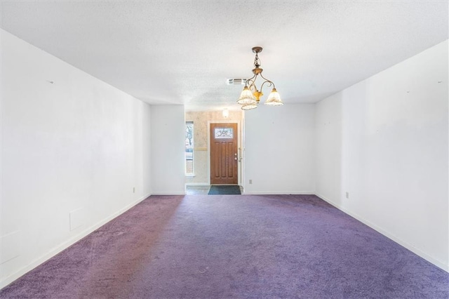 429 Bertolino Dr, Kenner, LA 70065 - carpeted empty room with baseboards, visible vents, an inviting chandelier, and a textured ceiling