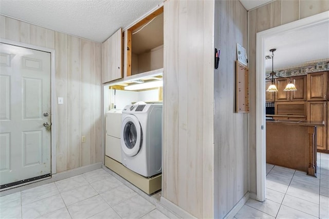 429 Bertolino Dr, Kenner, LA 70065 - washroom with washing machine and dryer, baseboards, wood walls, and laundry area