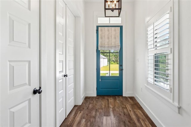 entryway with baseboards and dark wood-style flooring