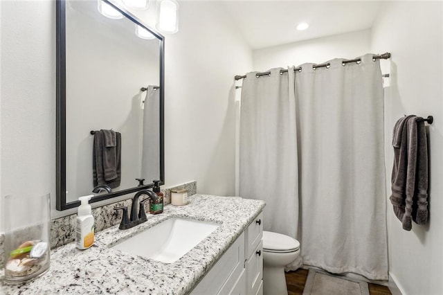 bathroom featuring recessed lighting, wood finished floors, toilet, vanity, and a shower with shower curtain