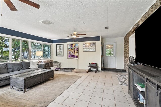 123 Robinhood Rd, Covington, LA 70433 - living area with plenty of natural light, light tile patterned floors, ceiling fan, and visible vents