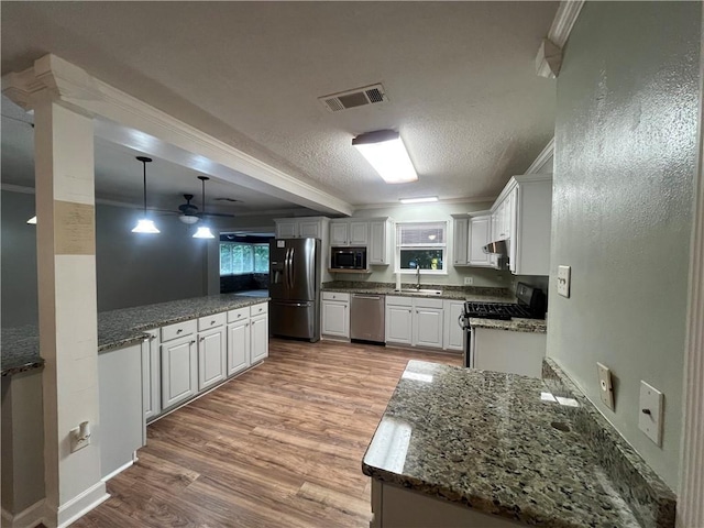 123 Robinhood Rd, Covington, LA 70433 - kitchen with refrigerator with ice dispenser, range with gas stovetop, black microwave, stainless steel dishwasher, and a sink