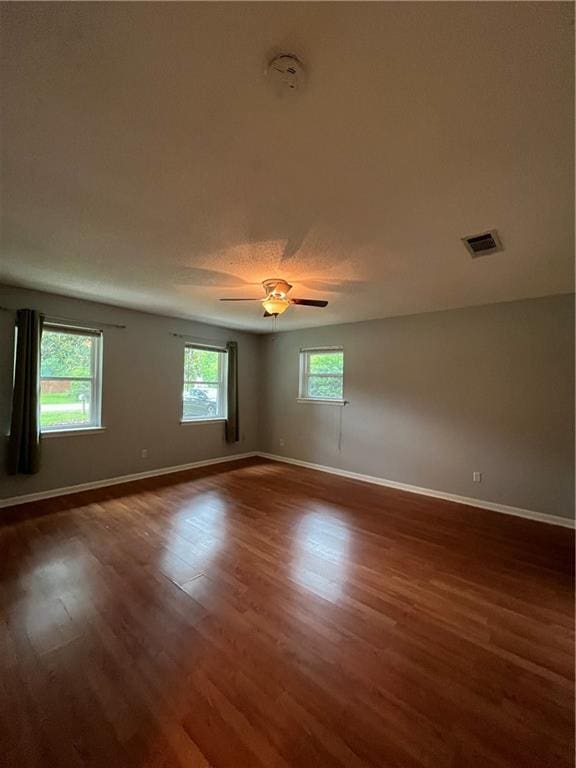 123 Robinhood Rd, Covington, LA 70433 - empty room featuring plenty of natural light, baseboards, and dark wood-type flooring