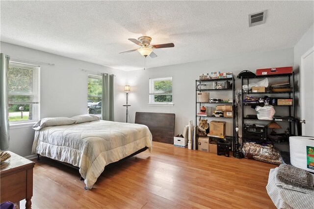 123 Robinhood Rd, Covington, LA 70433 - bedroom with visible vents, a textured ceiling, and light wood finished floors