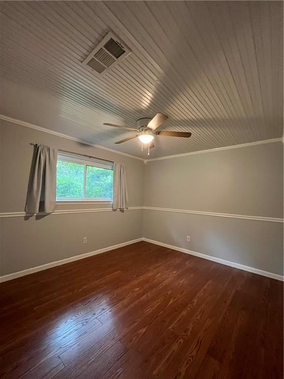 123 Robinhood Rd, Covington, LA 70433 - spare room with crown molding, wood ceiling, dark wood-style floors, baseboards, and ceiling fan