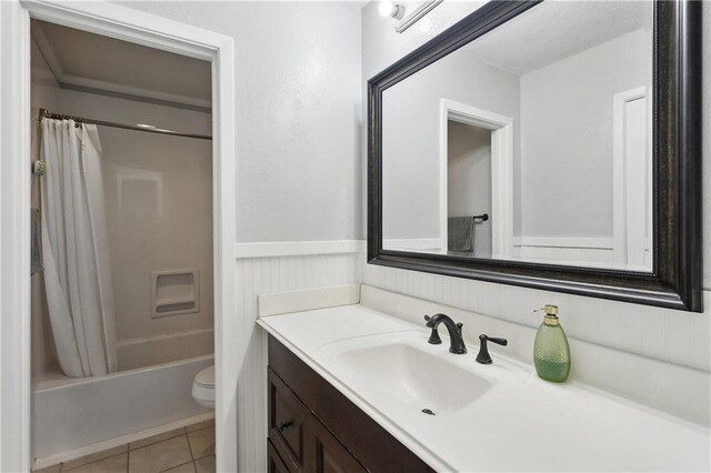 123 Robinhood Rd, Covington, LA 70433 - full bath featuring tile patterned flooring, wainscoting, vanity, toilet, and shower / tub combo with curtain