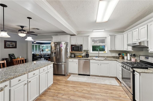 123 Robinhood Rd, Covington, LA 70433 - kitchen featuring appliances with stainless steel finishes, a sink, under cabinet range hood, white cabinets, and a textured ceiling