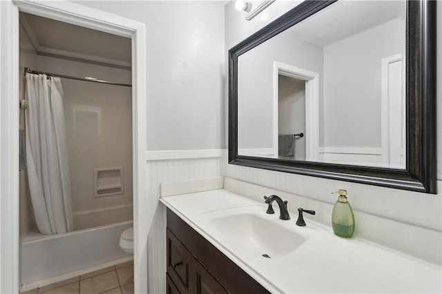 123 Robinhood Rd, Covington, LA 70433 - full bath featuring vanity, toilet, shower / tub combo, tile patterned flooring, and wainscoting