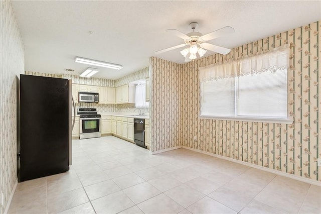 205 Newman Ave, Jefferson, LA 70121 - kitchen with a ceiling fan, wallpapered walls, light tile patterned floors, light countertops, and appliances with stainless steel finishes