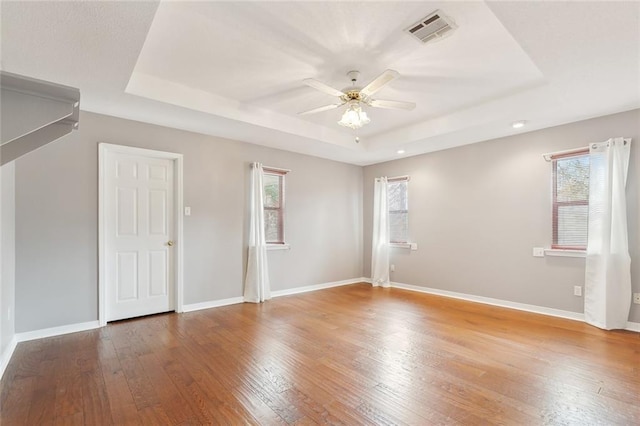 205 Newman Ave, Jefferson, LA 70121 - empty room with ceiling fan, a tray ceiling, visible vents, and plenty of natural light