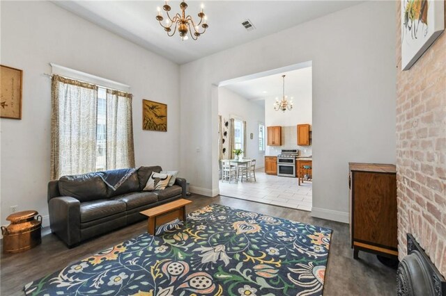 2426 Chippewa St, New Orleans, LA 70130 - living room featuring a chandelier, wood finished floors, and baseboards
