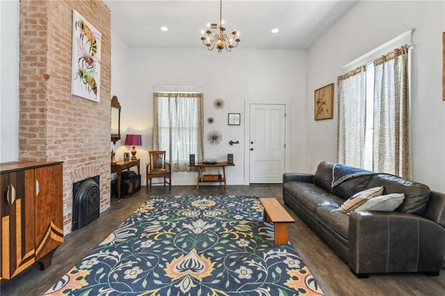 2426 Chippewa St, New Orleans, LA 70130 - living area with a chandelier, wood finished floors, a high ceiling, recessed lighting, and a brick fireplace