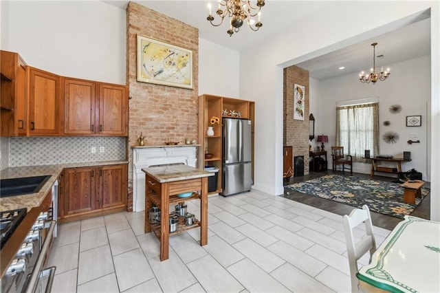2426 Chippewa St, New Orleans, LA 70130 - kitchen featuring appliances with stainless steel finishes, a chandelier, open shelves, brown cabinets, and a towering ceiling