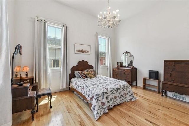2426 Chippewa St, New Orleans, LA 70130 - bedroom with multiple windows, a chandelier, and light wood finished floors