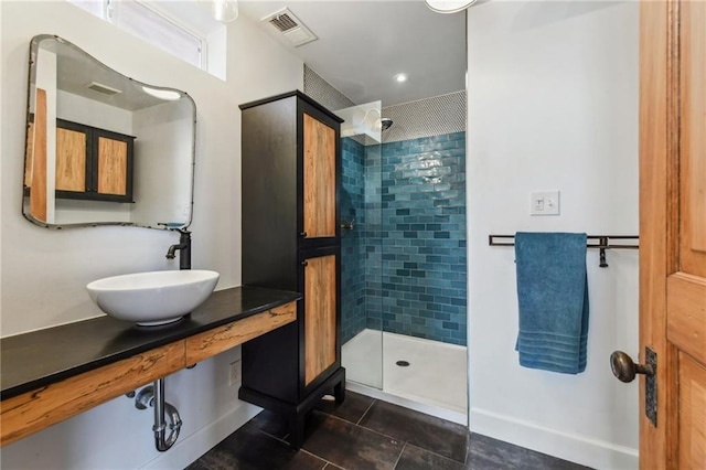 2426 Chippewa St, New Orleans, LA 70130 - bathroom with tile patterned floors, a sink, tiled shower, and baseboards