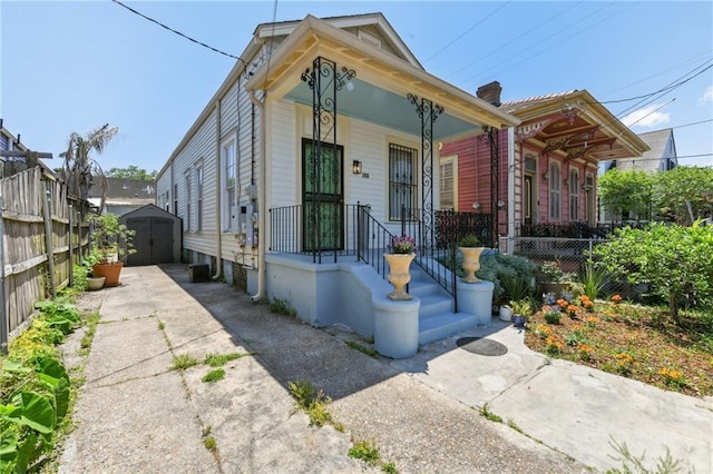 2426 Chippewa St, New Orleans, LA 70130 - shotgun-style home featuring a shed, an outdoor structure, and fence