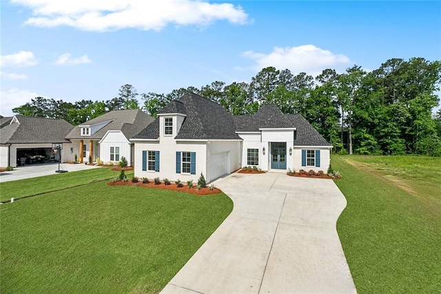 view of front of property with driveway, an attached garage, a shingled roof, a front yard, and stucco siding