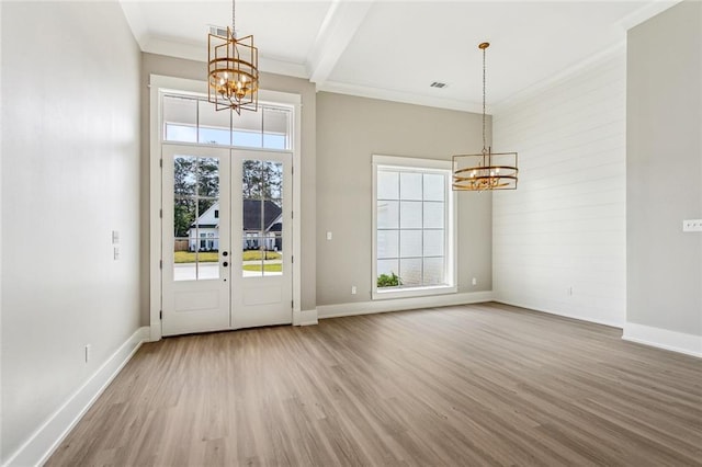 entrance foyer with baseboards, wood finished floors, and a notable chandelier